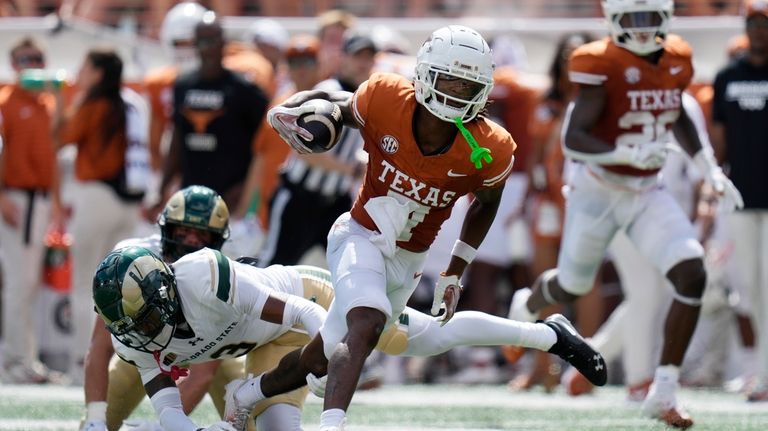 Texas wide receiver Isaiah Bond, center, runs against Colorado State...