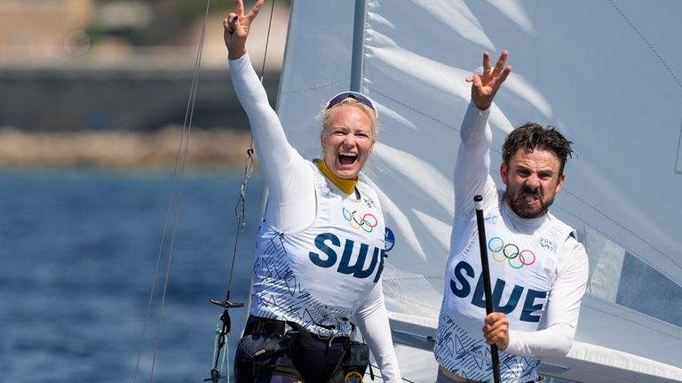 Lovisa Karlsson and Anton Dahlberg of Sweden celebrate after the...