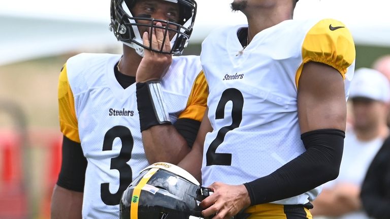 Pittsburgh Steelers quarterbacks Russell Wilson, left, and Justin Fields chat...