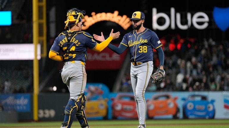 Milwaukee Brewers pitcher Devin Williams (38) is congratulated by catcher...