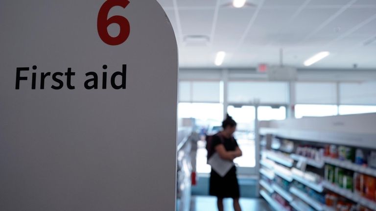 A customer browses the first aid aisle at a Walgreens...