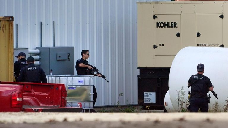 Law enforcement search a farm for the Army reservist Robert...