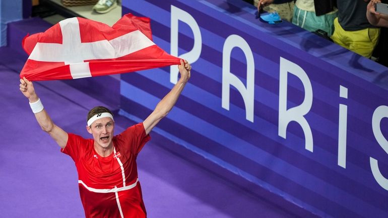 Denmark's Viktor Axelsen celebrates after defeating Thailand's Kunlavut Vitidsarn during...