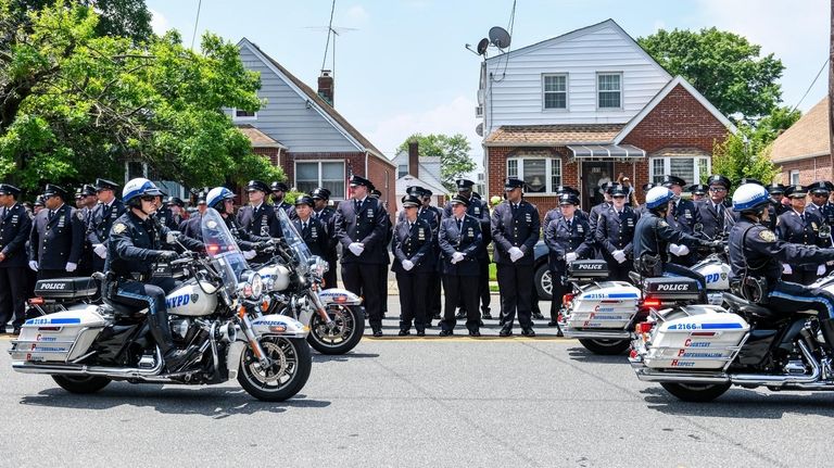 Fellow police officers gather for the funeral of the NYPD's Emilia...