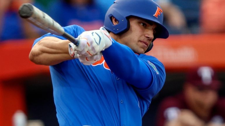 Florida utility Jac Caglianone hits a single in the first...