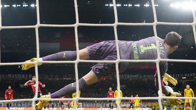Dortmund's goalkeeper Gregor Kobel saves on a penalty kick by...
