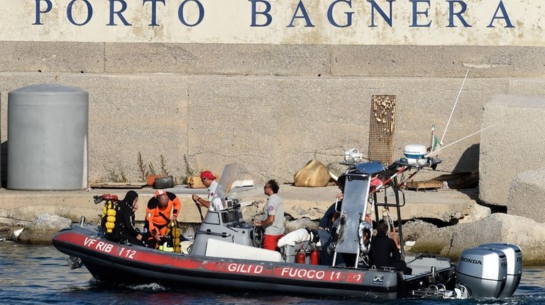 Scuba divers arrive at the harbor of Porticello, southern Italy,...