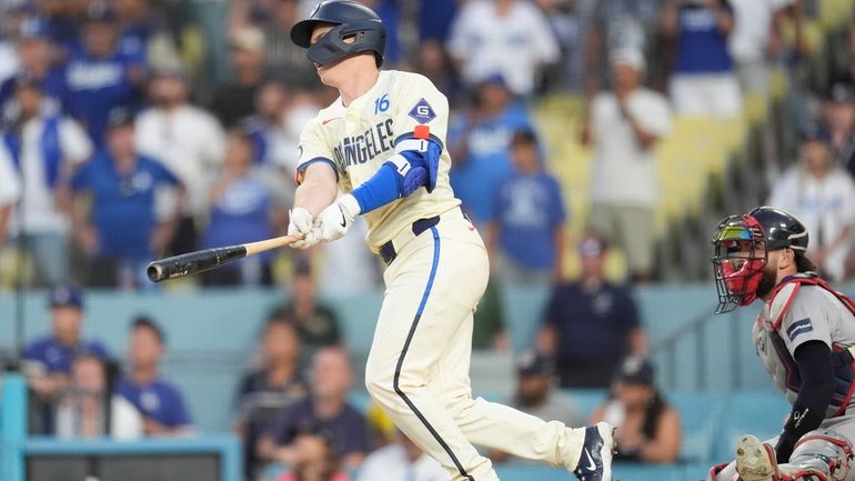 Los Angeles Dodgers' Will Smith, left, drives in the winning...