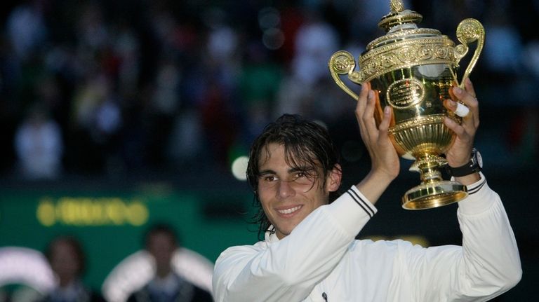 Spain's Rafael Nadal holds his trophy as he celebrates his...