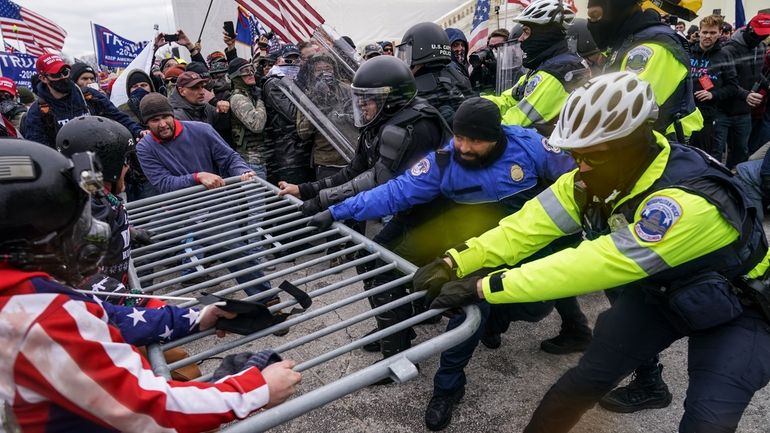 Supporters of President Donald Trump try to break through a...