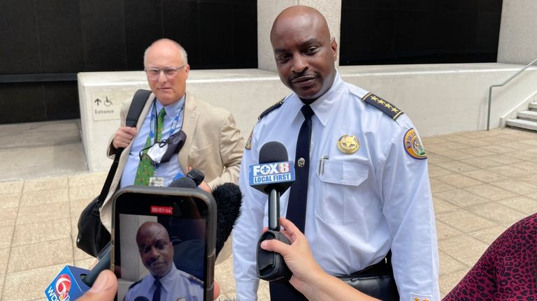 New Orleans Police Superintendent Shaun Ferguson talks to reporters outside...