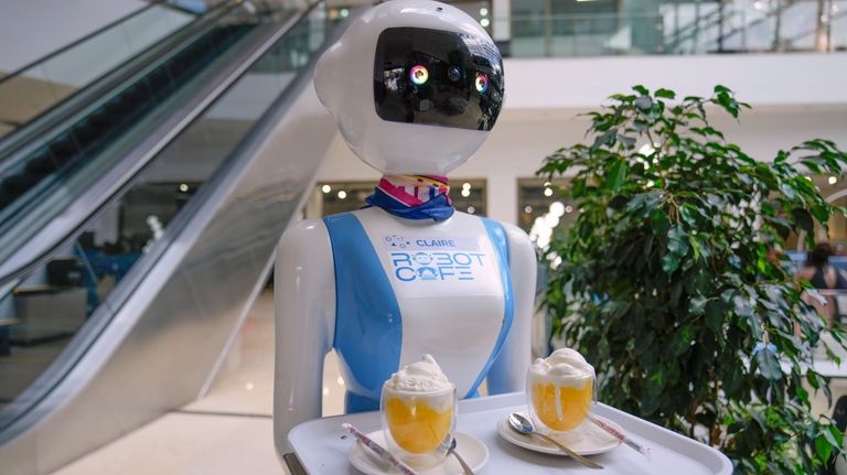 Robotic waiter Claire, delivers an order to customers at the...