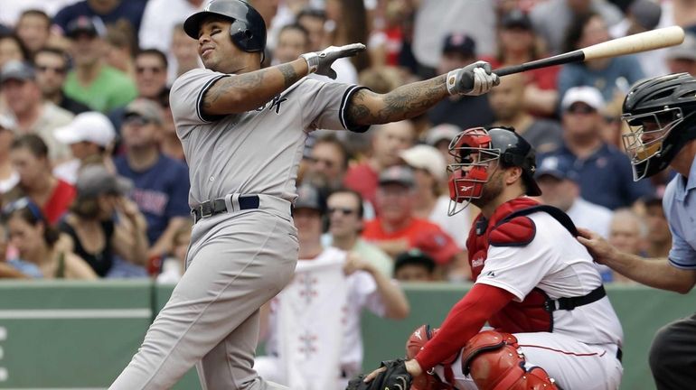 New York Yankees' Andruw Jones follows through on a solo...