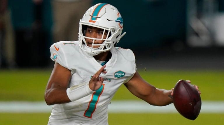 Dolphins quarterback Tua Tagovailoa looks to pass during the second half...