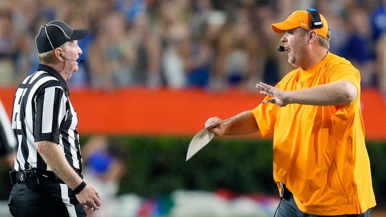 Tennessee head coach Josh Heupel, right, has words with head...