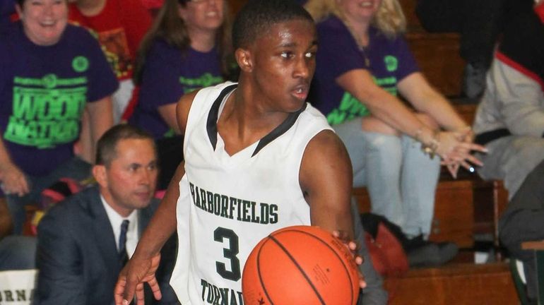 Harborfields Malcolm Wynter (3) carries the ball in the third...