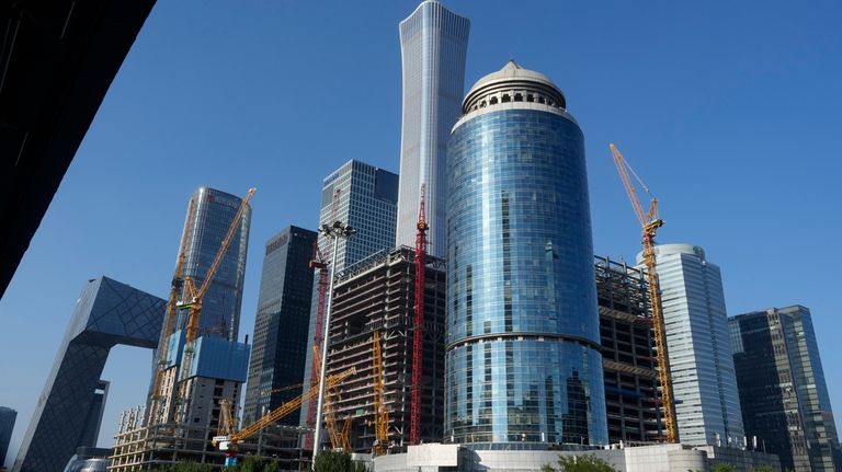 Construction cranes are seen near the central business district in...