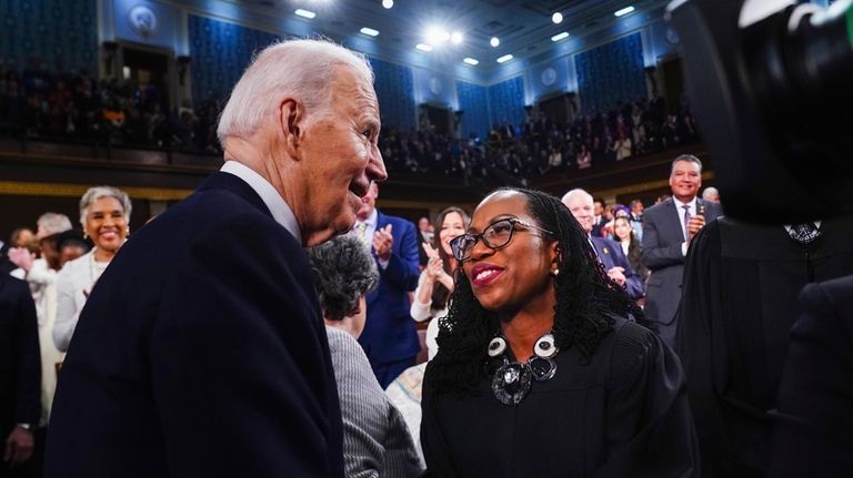 President Joe Biden, left, greets Justice Ketanji Brown Jackson as...