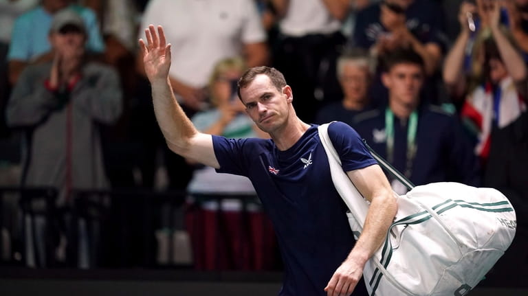 Great Britain's Andy Murray waves to the crowd after beating...