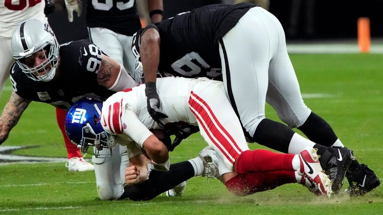 Giants quarterback Daniel Jones is sacked by Raiders defensive end Maxx...