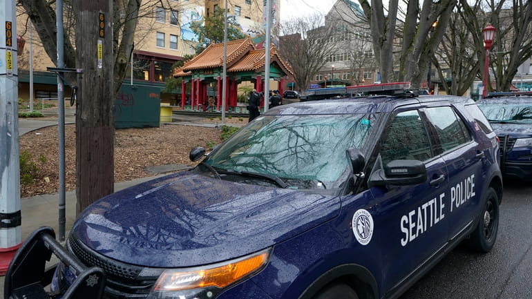 A Seattle Police Department vehicle sits parked at Hing Hay...