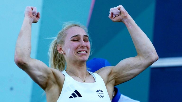 Janja Garnbret of Slovenia reacts after winning the gold during...