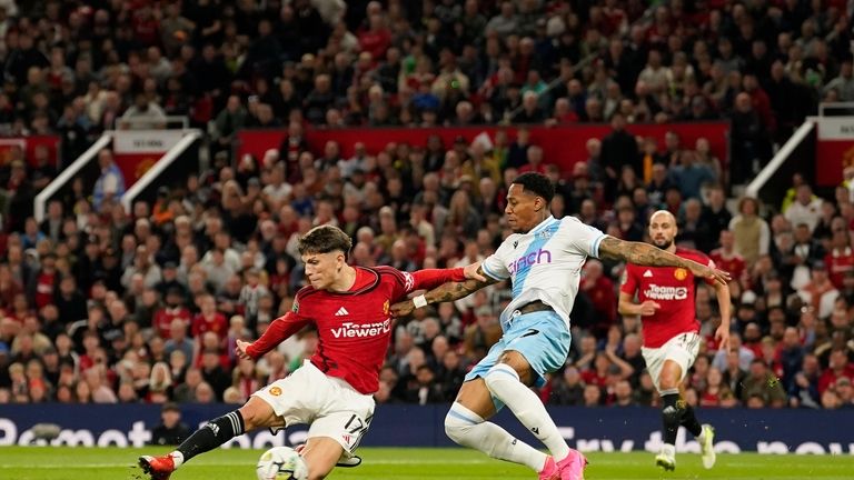 Manchester United's Alejandro Garnacho, left, scores his side's opening goal...