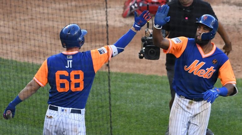 The Mets' Jeff McNeil, left, greets Amed Rosario after his...