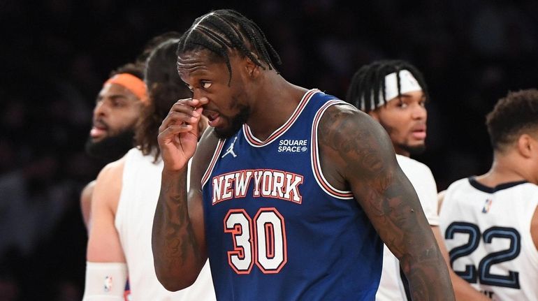 Knicks forward Julius Randle walks to the bench during a...