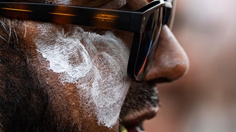 Sheaka Morshed wears sunblock on his face as temperatures climb...