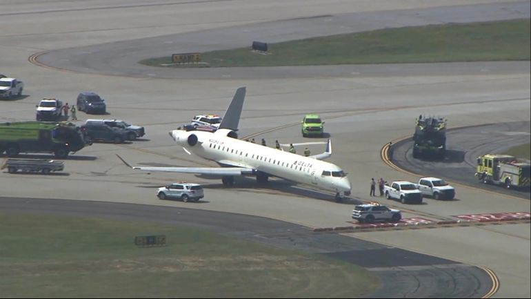 A plane sits damaged at Hartsfield-Jackson Atlanta International Airport after...