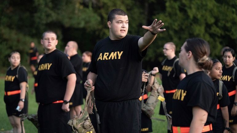 Students gather during physical training exercises in the new Army...