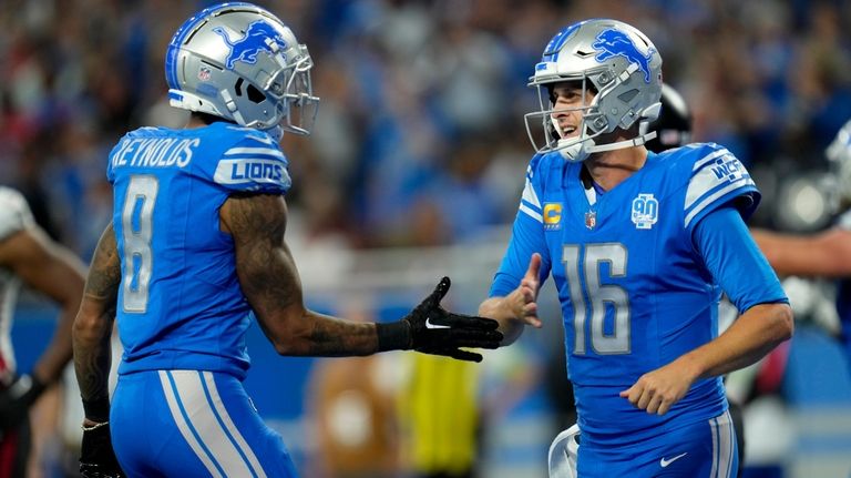 Detroit Lions quarterback Jared Goff (16) celebrates his touchdown run...