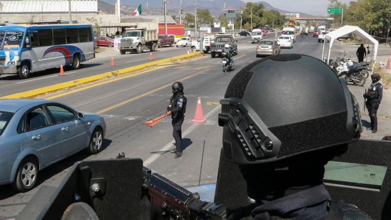 State police maintain a security checkpoint at the entrance of...