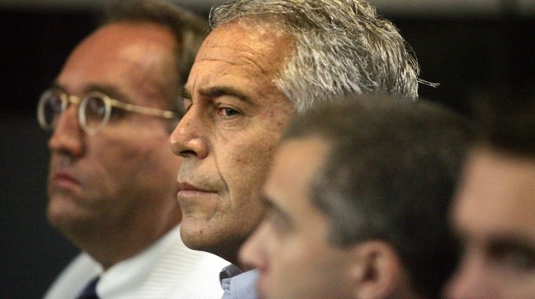 Jeffrey Epstein, center, appears in court in West Palm Beach,...