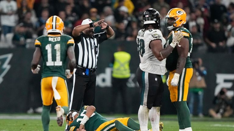 Green Bay Packers quarterback Jordan Love (10) gets hurt during...