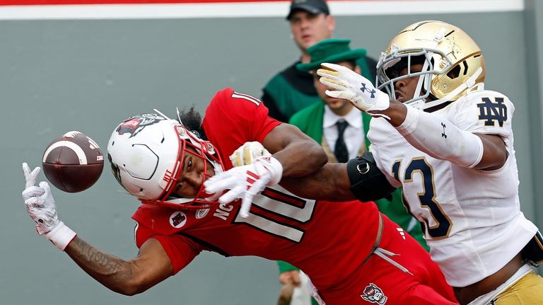 North Carolina State's Kevin Concepcion (10) tries to maintain control...