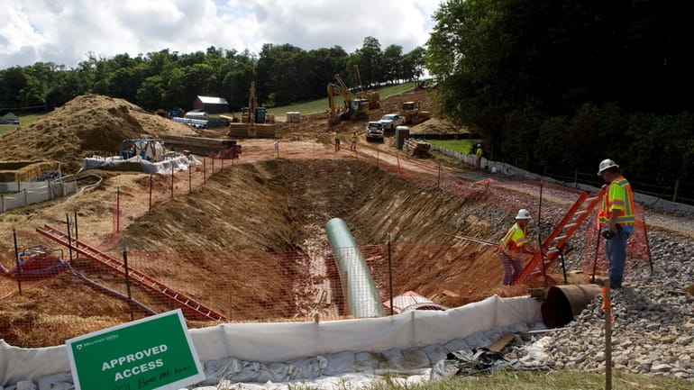 Construction crews bore beneath U.S. 221 in Roanoke County, Va.,...