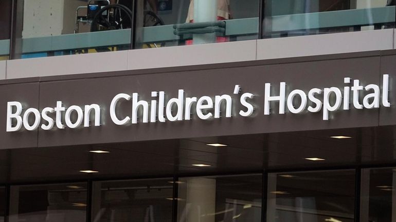 A sign hangs on the Boston Children's Hospital, Aug. 18,...