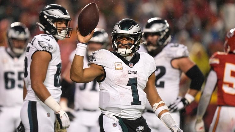 Philadelphia Eagles quarterback Jalen Hurts celebrates after scoring on a...