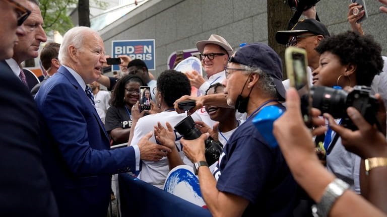 President Joe Biden, left, greets supporters, Thursday, June 27, 2024,...