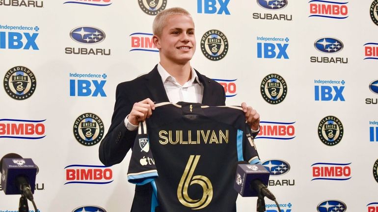 Philadelphia Union player Cavan Sullivan, 14, holds up his No....