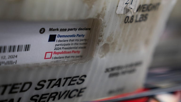 Vote-by-mail ballots for the presidential primary election are seen on...