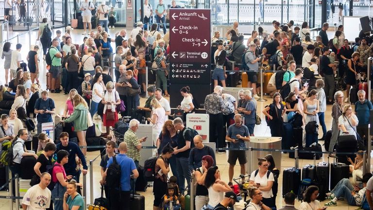 Passengers wait in front of check-in counters at the capital's...