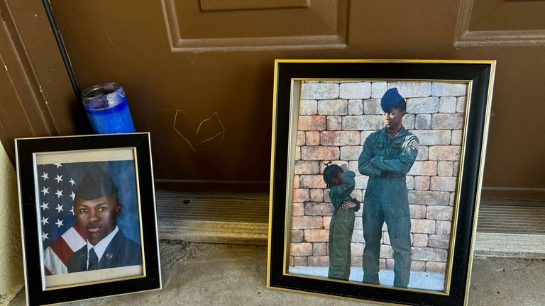 Candles and framed photos of Roger Fortson, a U.S. Air...