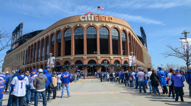 Mets fans wait in line for Opening Day against the...