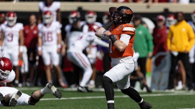 Oklahoma State quarterback Alan Bowman (7) throws a pass in...