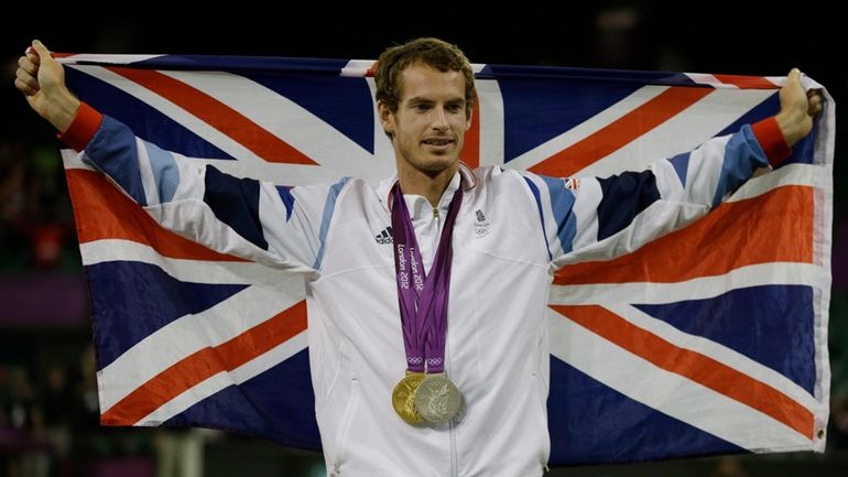 Andy Murray of Great Britain poses with his gold and...