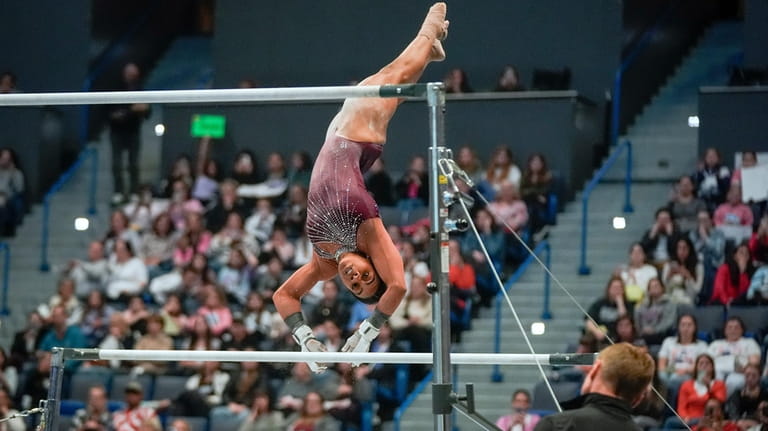Gabby Douglas competes on the uneven bars during the U.S....