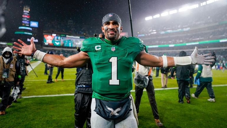 Philadelphia Eagles quarterback Jalen Hurts celebrates after scoring the game...